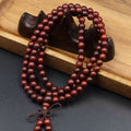 108 smooth sandalwood bead meditation bracelet with natural wood grain for mindfulness practice displayed