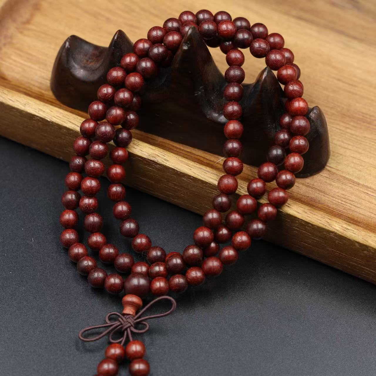 108 smooth sandalwood bead meditation bracelet with natural wood grain for mindfulness practice displayed