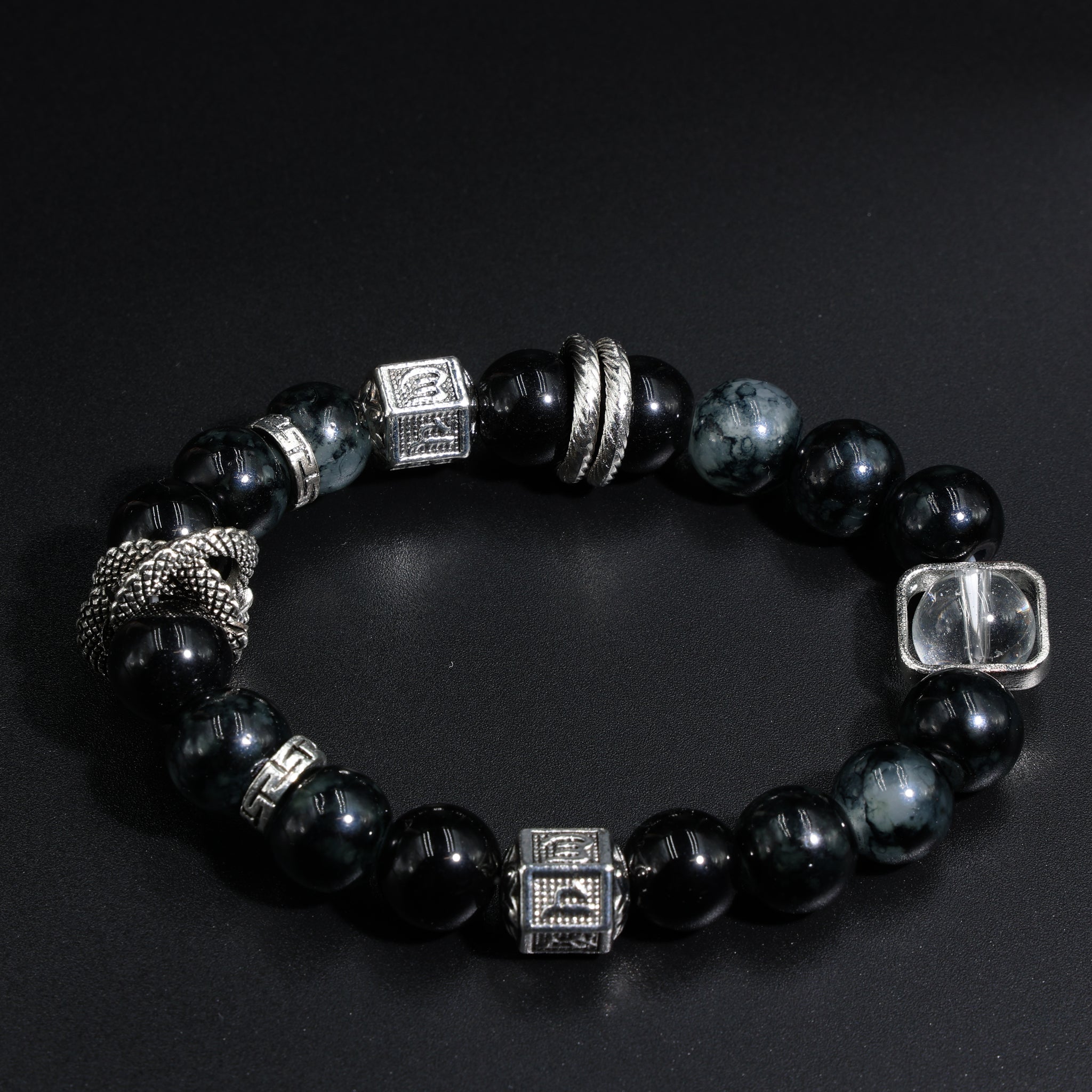wearing obsidian snake bracelet in tree pose, charm resting on ankle chakra during sunset meditation