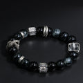 wearing obsidian snake bracelet in tree pose, charm resting on ankle chakra during sunset meditation