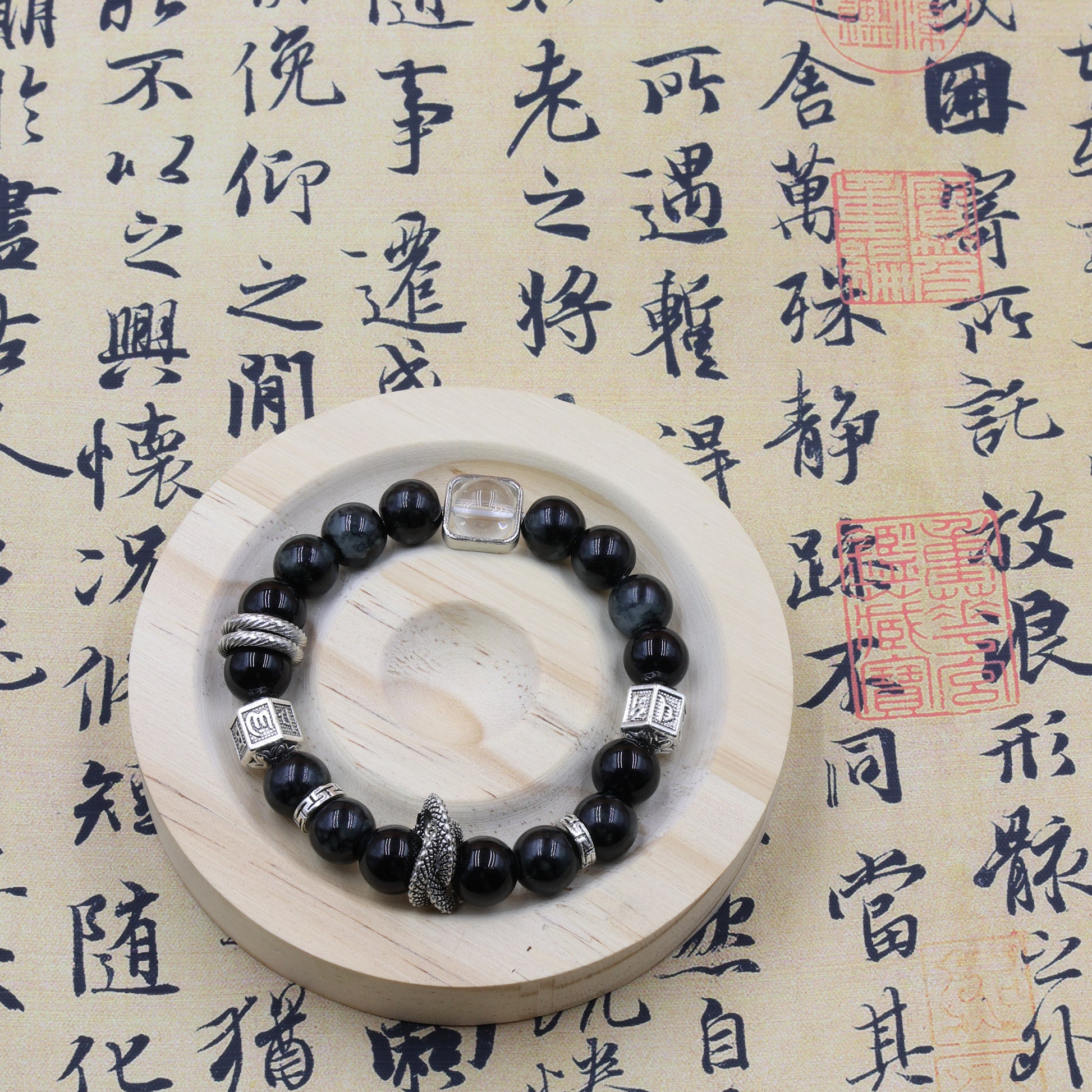 wearing obsidian snake bracelet in tree pose, charm resting on ankle chakra during sunset meditation